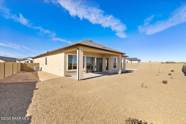 rear view of house featuring a fenced backyard, a patio, central AC unit, and stucco siding