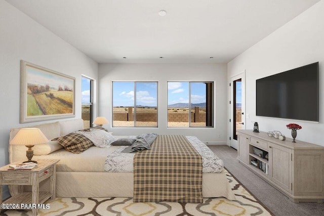 bedroom with baseboards and light colored carpet