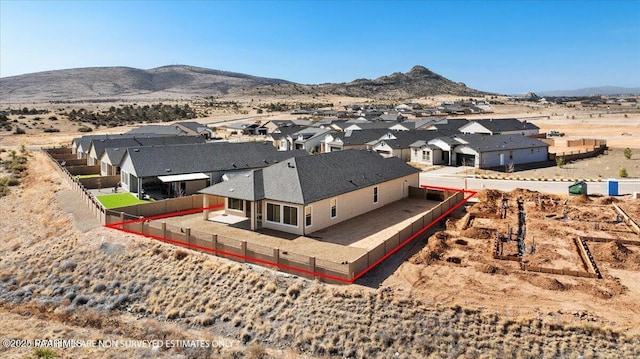 birds eye view of property featuring a mountain view and a residential view