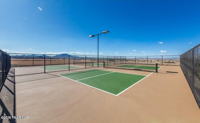 view of tennis court featuring fence