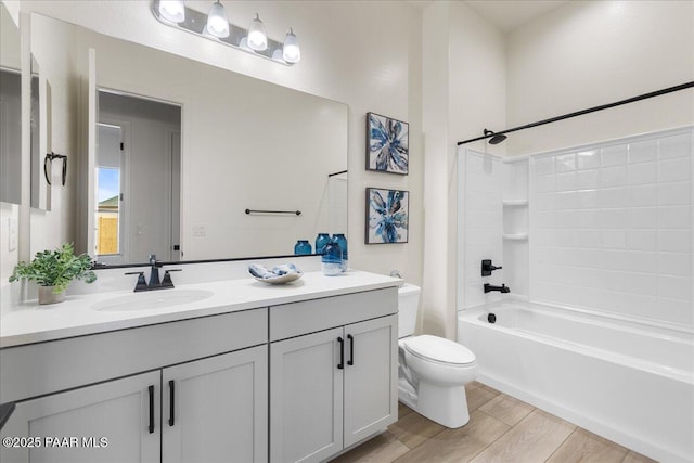 full bathroom with toilet, bathtub / shower combination, wood finished floors, and vanity