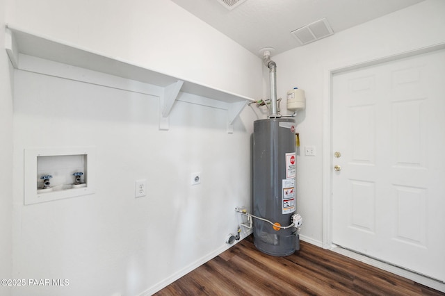 clothes washing area with electric dryer hookup, gas water heater, laundry area, hookup for a washing machine, and dark wood-style flooring