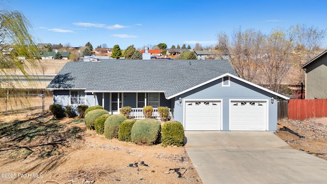 ranch-style house featuring a porch, driveway, a shingled roof, and fence