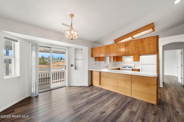 kitchen with white appliances, visible vents, lofted ceiling, arched walkways, and a sink