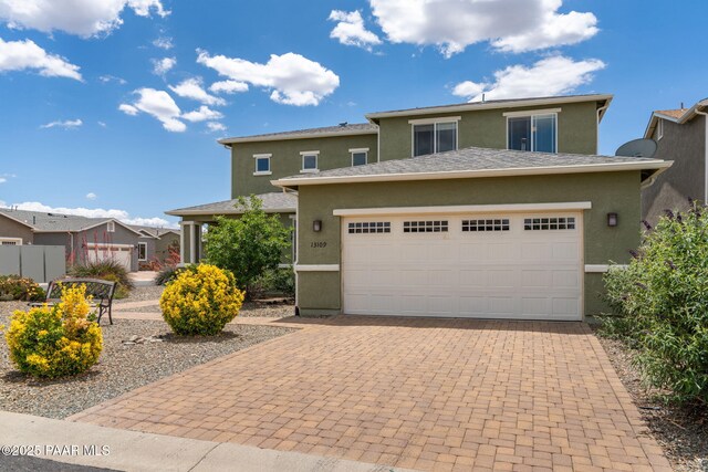 13109 E Gonzalez St, Dewey-Humboldt, AZ 86327 - view of front of property featuring stucco siding, a garage, and decorative driveway