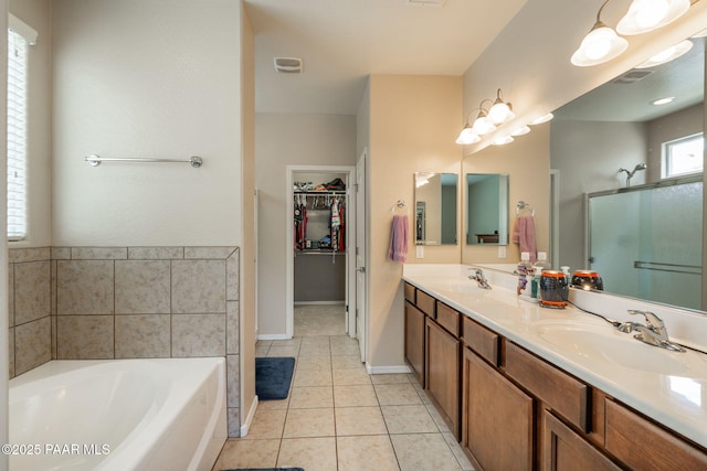 13109 E Gonzalez St, Dewey-Humboldt, AZ 86327 - full bathroom with double vanity, a bath, a shower stall, tile patterned flooring, and a spacious closet