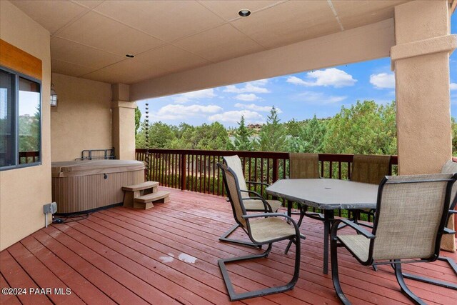 wooden deck featuring a hot tub