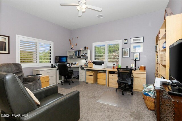 home office with light carpet, plenty of natural light, and ceiling fan