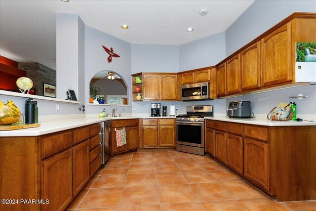 kitchen with light tile patterned floors, sink, and appliances with stainless steel finishes