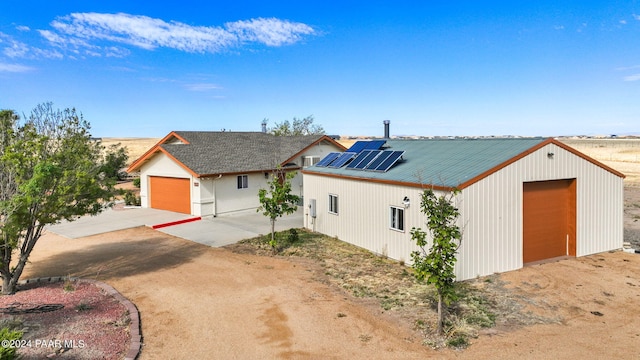 modern farmhouse style home with solar panels and an outdoor structure