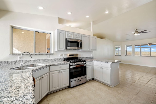 kitchen featuring white cabinets, stainless steel appliances, vaulted ceiling, and sink