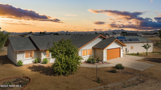 view of front of property with a mountain view and a garage