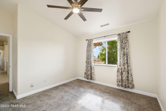 unfurnished room featuring ceiling fan, visible vents, baseboards, vaulted ceiling, and carpet