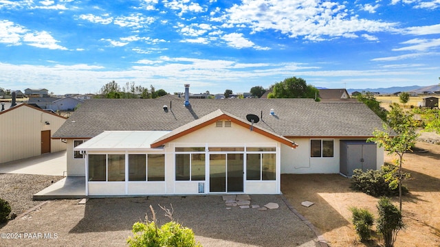 back of house featuring a patio area and a sunroom