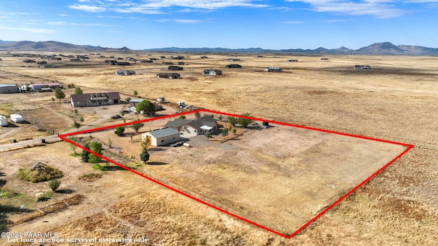 drone / aerial view with view of desert, a mountain view, and a rural view