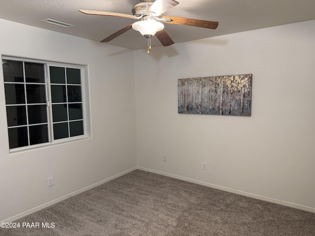 spare room with carpet flooring and ceiling fan