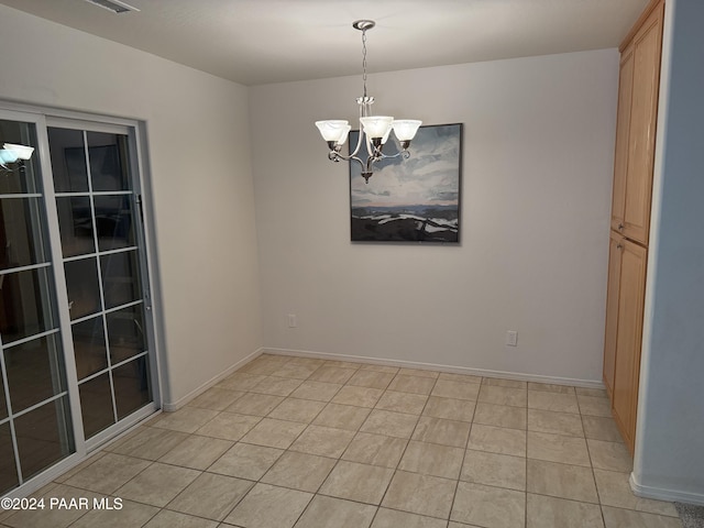 unfurnished room featuring light tile patterned flooring and an inviting chandelier