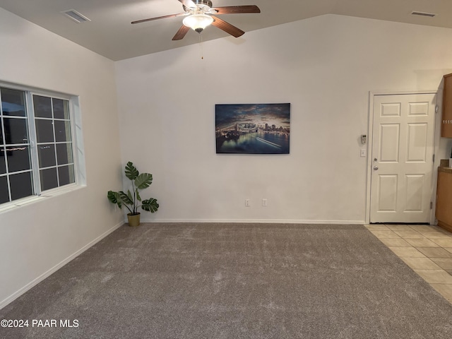 carpeted empty room featuring ceiling fan and vaulted ceiling