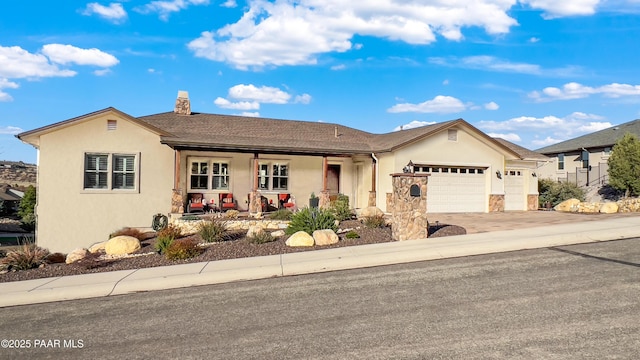 4374 Hornet Dr, Prescott, AZ 86301 - single story home featuring stucco siding, an attached garage, driveway, a chimney, and a porch