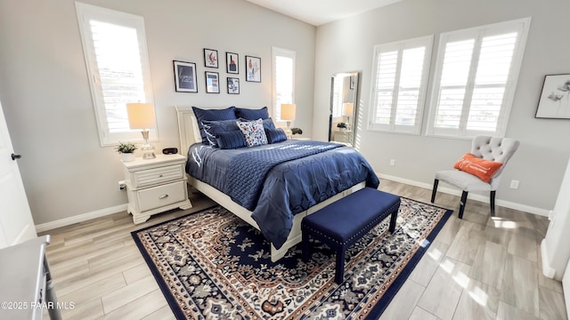 4374 Hornet Dr, Prescott, AZ 86301 - bedroom featuring multiple windows, baseboards, and light wood-style floors