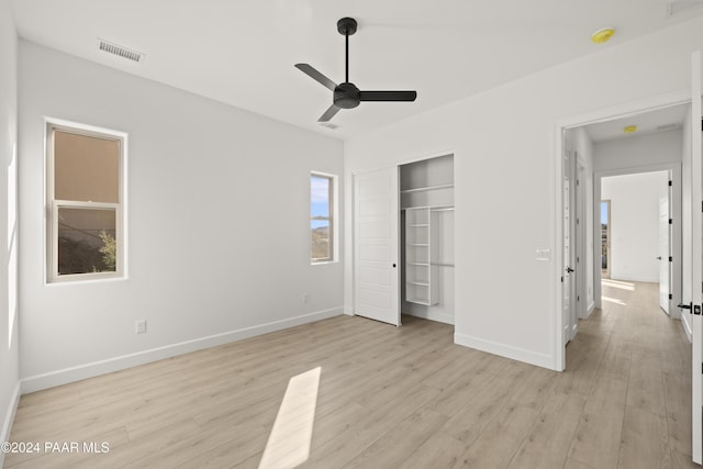 unfurnished bedroom featuring a closet, ceiling fan, and light hardwood / wood-style flooring