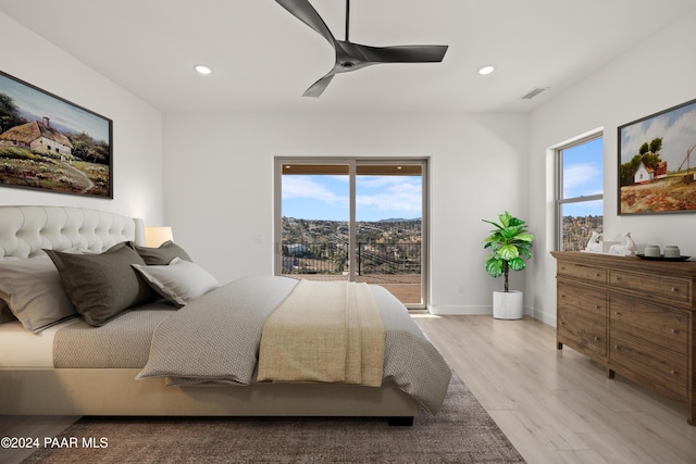 bedroom with ceiling fan, access to exterior, light wood-type flooring, and multiple windows