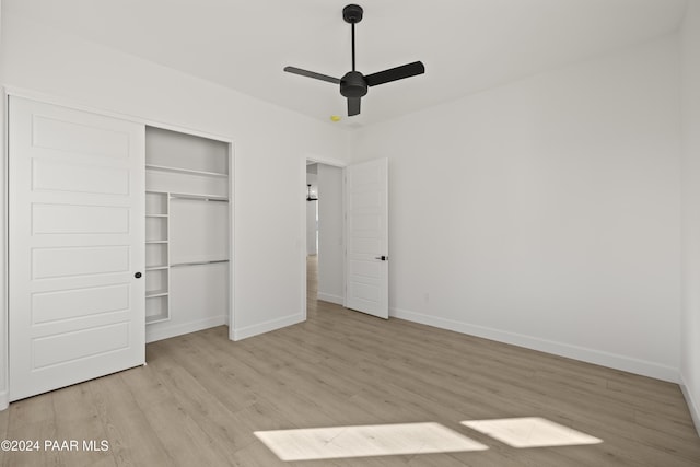 unfurnished bedroom with a closet, ceiling fan, and light hardwood / wood-style flooring