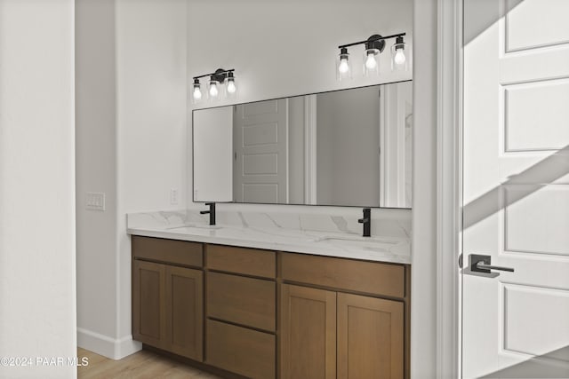 bathroom featuring hardwood / wood-style flooring and vanity