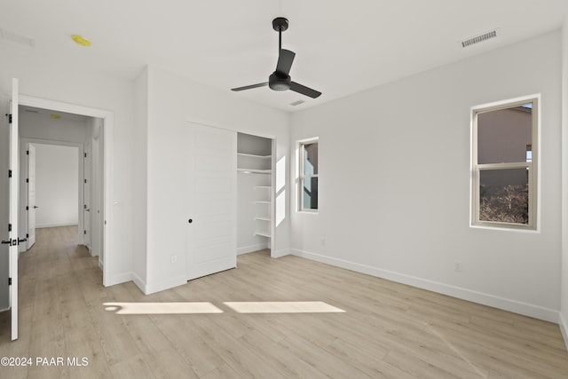 unfurnished bedroom featuring a closet, ceiling fan, and light hardwood / wood-style flooring