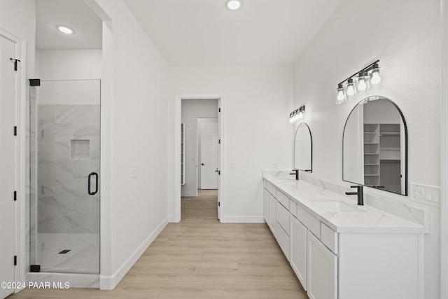 bathroom featuring vanity, an enclosed shower, and hardwood / wood-style flooring