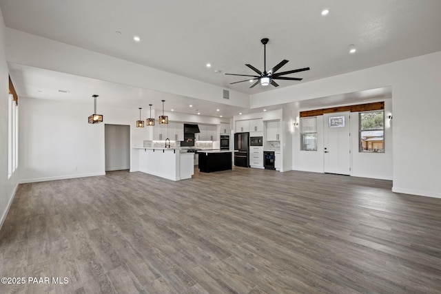 3225 Pamela St, Prescott, AZ 86305 - unfurnished living room with dark wood-type flooring, a sink, ceiling fan, baseboards, and recessed lighting
