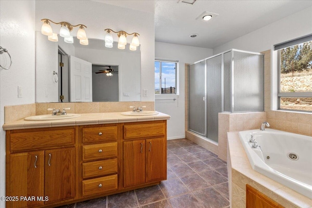 20775 N Hackamore Ln, Paulden, AZ 86334 - full bathroom with a stall shower, a tub with jets, double vanity, baseboards, and ceiling fan