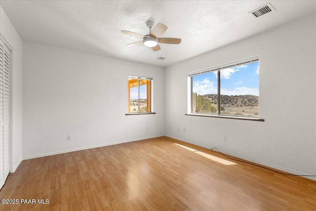 20775 N Hackamore Ln, Paulden, AZ 86334 - empty room featuring a ceiling fan, light wood-type flooring, baseboards, and a textured ceiling