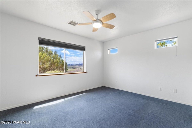 20775 N Hackamore Ln, Paulden, AZ 86334 - empty room with ceiling fan, dark carpet, and baseboards