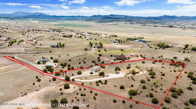 20775 N Hackamore Ln, Paulden, AZ 86334 - aerial view of sparsely populated area featuring property boundaries highlighted, a mountainous background, and a desert landscape