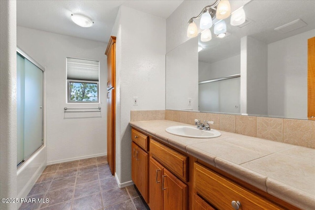 20775 N Hackamore Ln, Paulden, AZ 86334 - full bath with vanity, baseboards, and bath / shower combo with glass door