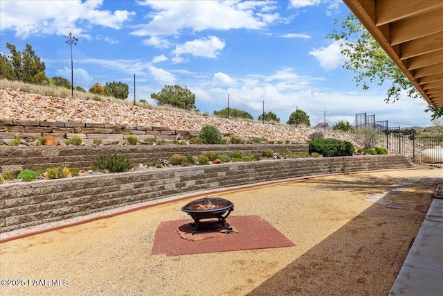 20775 N Hackamore Ln, Paulden, AZ 86334 - view of patio / terrace with an outdoor fire pit and fence