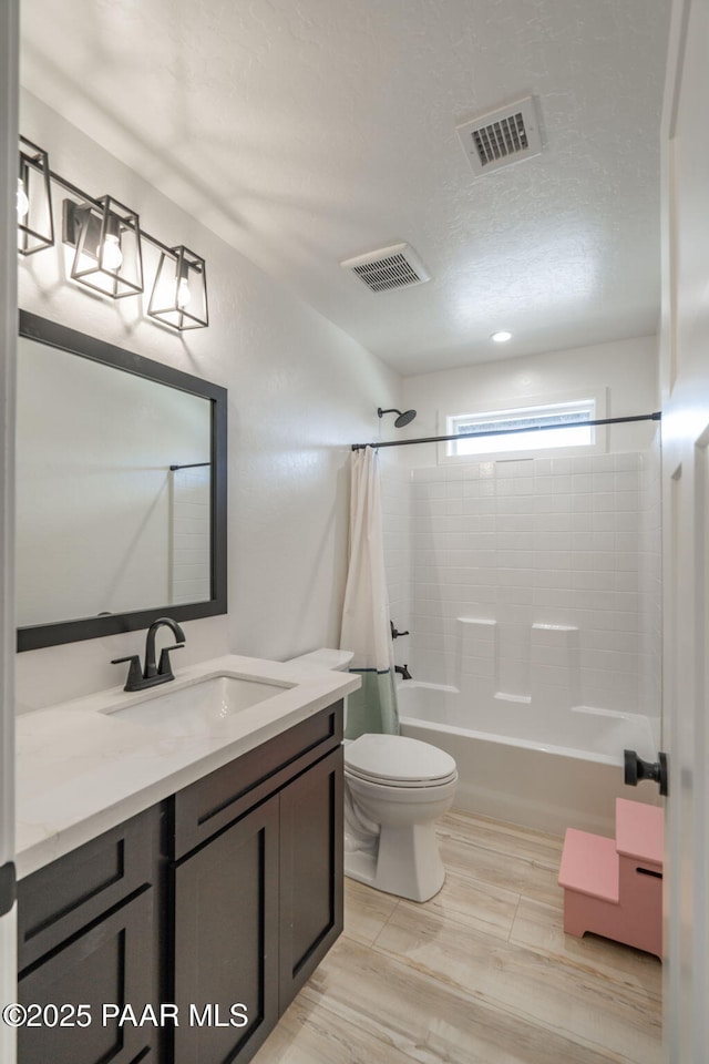 2905 S Omega Dr, Dewey-Humboldt, AZ 86329 - bathroom featuring vanity, toilet, shower / bath combination with curtain, and a textured ceiling