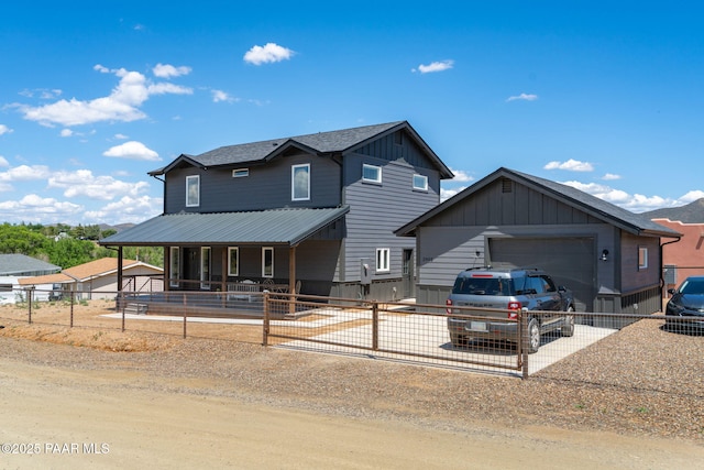 2905 S Omega Dr, Dewey-Humboldt, AZ 86329 - view of front of property with an attached garage, dirt driveway, a porch, a fenced front yard, and board and batten siding