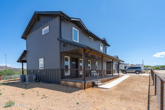 2905 S Omega Dr, Dewey-Humboldt, AZ 86329 - rear view of house with a porch, board and batten siding, and central AC