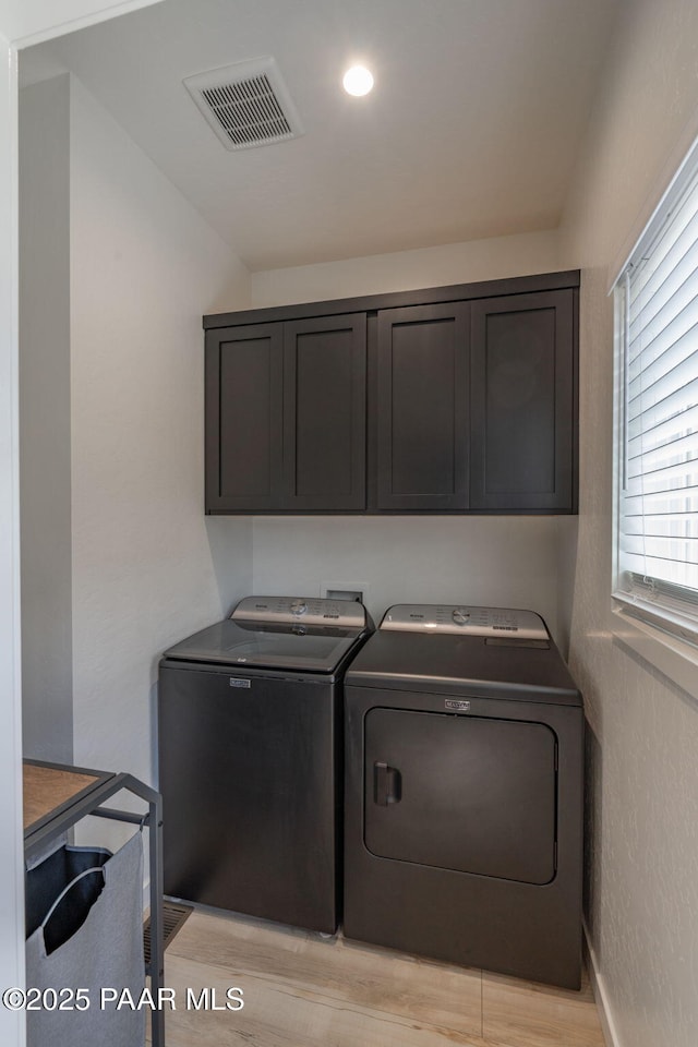 2905 S Omega Dr, Dewey-Humboldt, AZ 86329 - washroom featuring washer and clothes dryer, cabinet space, and light wood-style floors
