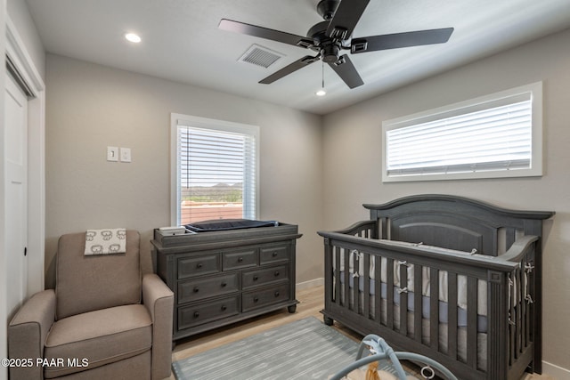 2905 S Omega Dr, Dewey-Humboldt, AZ 86329 - bedroom with multiple windows, wood finished floors, a crib, recessed lighting, and a closet