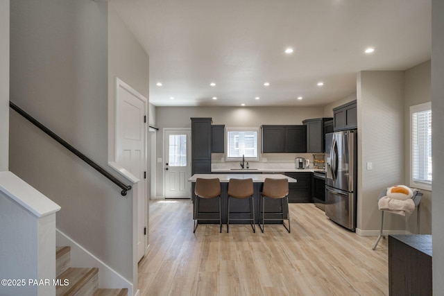 2905 S Omega Dr, Dewey-Humboldt, AZ 86329 - kitchen with stainless steel refrigerator with ice dispenser, light countertops, a sink, a breakfast bar area, and a kitchen island