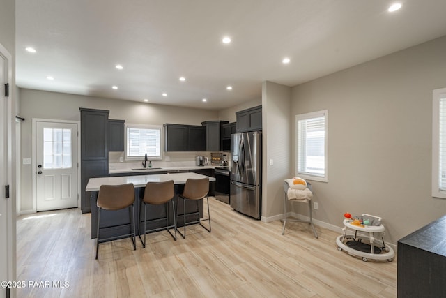 2905 S Omega Dr, Dewey-Humboldt, AZ 86329 - kitchen with stainless steel refrigerator with ice dispenser, a sink, light countertops, a center island, and light wood-type flooring