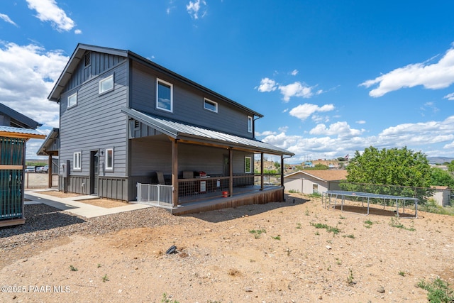 2905 S Omega Dr, Dewey-Humboldt, AZ 86329 - rear view of house featuring a trampoline, board and batten siding, and a patio