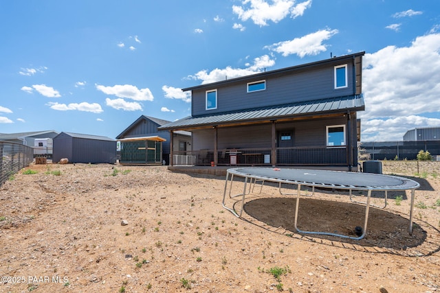 2905 S Omega Dr, Dewey-Humboldt, AZ 86329 - back of property featuring a trampoline, central AC unit, metal roof, and an outdoor structure