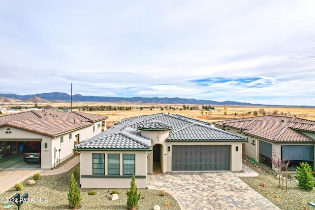 mediterranean / spanish-style house featuring a mountain view and a garage