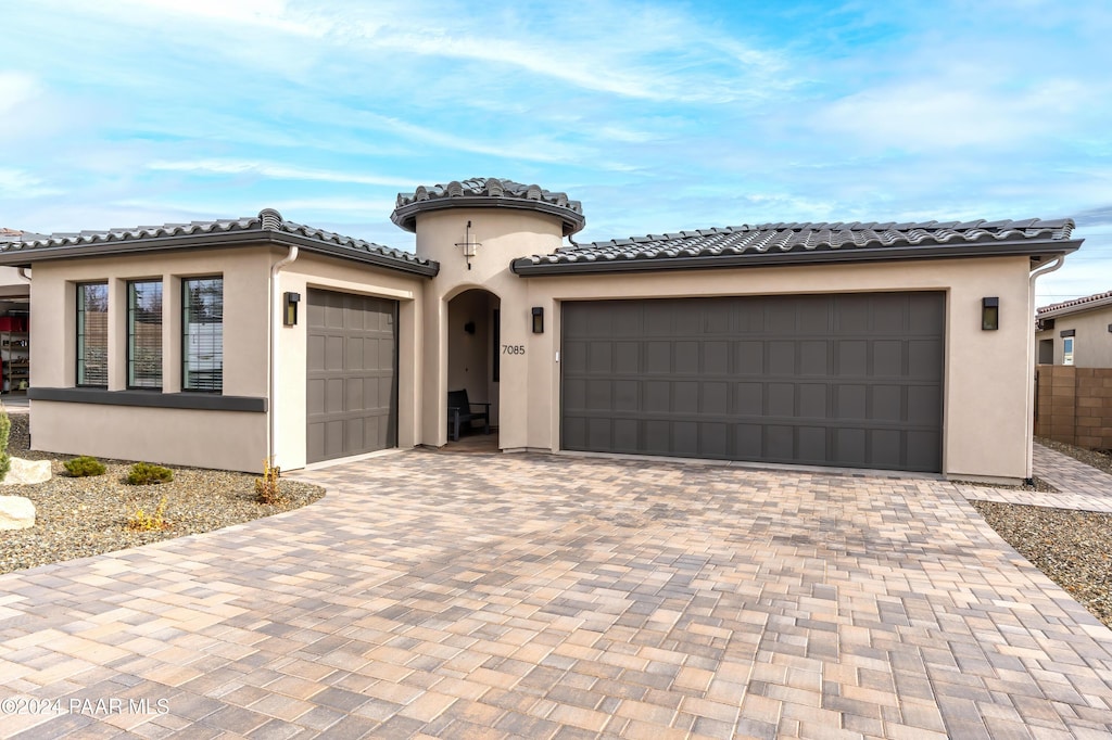 mediterranean / spanish-style house featuring a garage