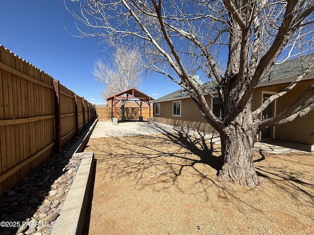 view of yard featuring a gazebo and a fenced backyard