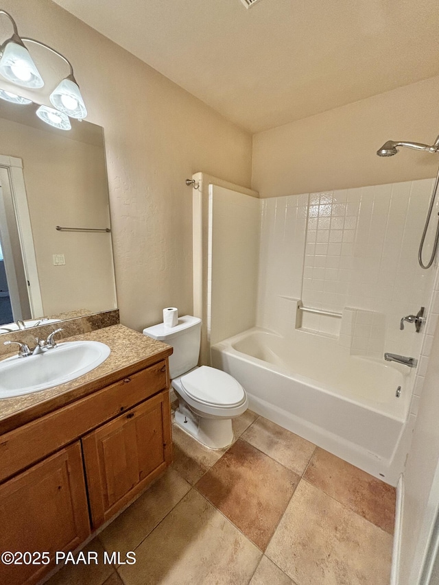 full bathroom with toilet, vanity, and washtub / shower combination